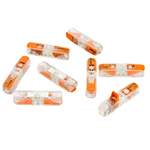 Zestaw 24 szybkozłączek WAGO 221, przeznaczonych do przewodów o średnicy 0,2-4mm². Złącza mają przezroczystą obudowę z pomarańczowymi elementami, umożliwiającymi łatwe podłączenie drutów. Widoczne oznaczenia na obudowie.