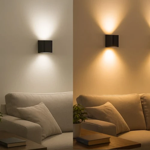 Żarówka LED GU10 4W z mleczną szybką, emituje neutralne białe światło. W tle widoczna kanapa z poduszkami, a na ścianie zamontowana czarna oprawa oświetleniowa, która rzuca światło w górę i w dół, tworząc efekt świetlny.