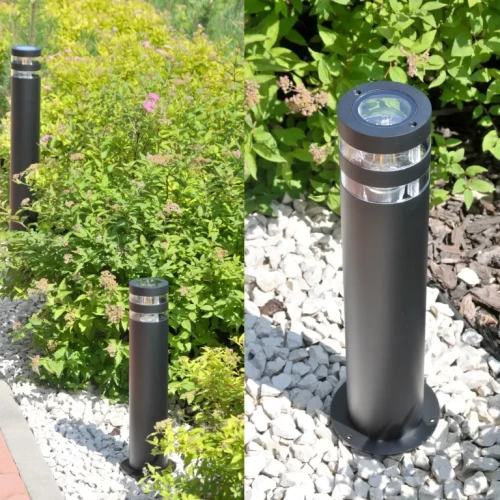 Lampa ogrodowa słupek RINO o wysokości 44 cm, w kolorze czarnym, okrągła, z przezroczystymi detalami u góry. Ustawiona na białych kamieniach, otoczona zielonymi roślinami. Widok z boku i z bliska na elementy konstrukcyjne.