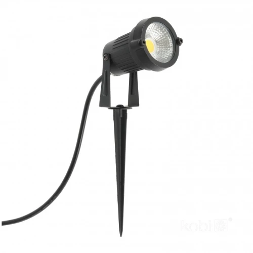 Reflektor ogrodowy LED BLAKE 5W 3000K IP65 w kolorze czarnym, zamontowany na stelażu z ostrym końcem do wbicia w ziemię. Oświetlenie posiada okrągłą soczewkę i jest podłączone do kabla zasilającego.