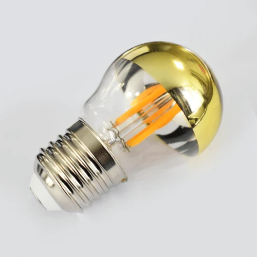 Żarówka LED filament E27 G45 4W w złotej oprawie, z przezroczystym kloszem, ukazuje widoczne żarniki w formie filamentów w kolorze pomarańczowym. Produkt jest ustawiony pod kątem, eksponując detal żarnika i srebrny gwint.