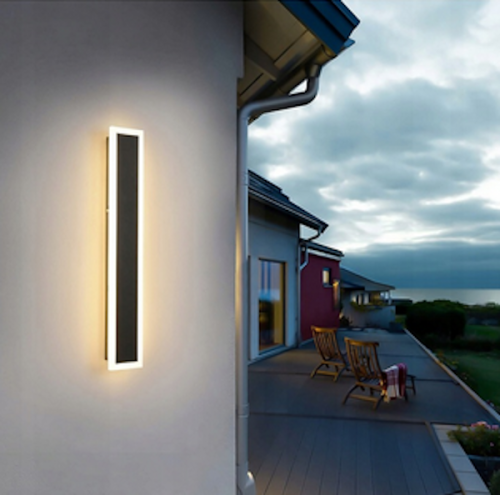 Kinkiet elewacyjny DURANGO o długości 30 cm, czarny z podświetleniem LED. Montowany na ścianie, prostokątny kształt, minimalistyczny design. Widoczny na tle elewacji budynku, w otoczeniu tarasu.